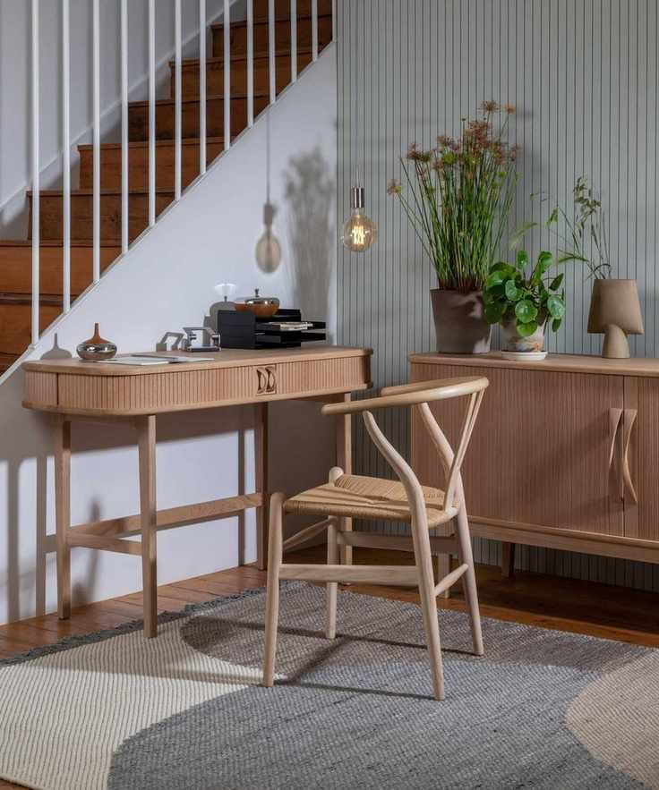 Light wood desk with wishbone chair