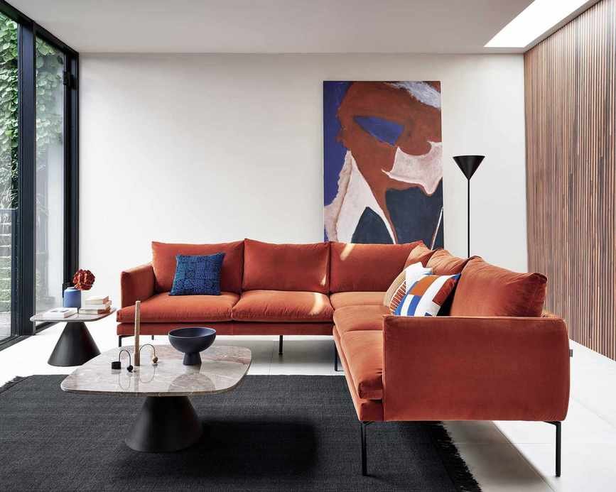 Space-saving corner sofa in rust velvet