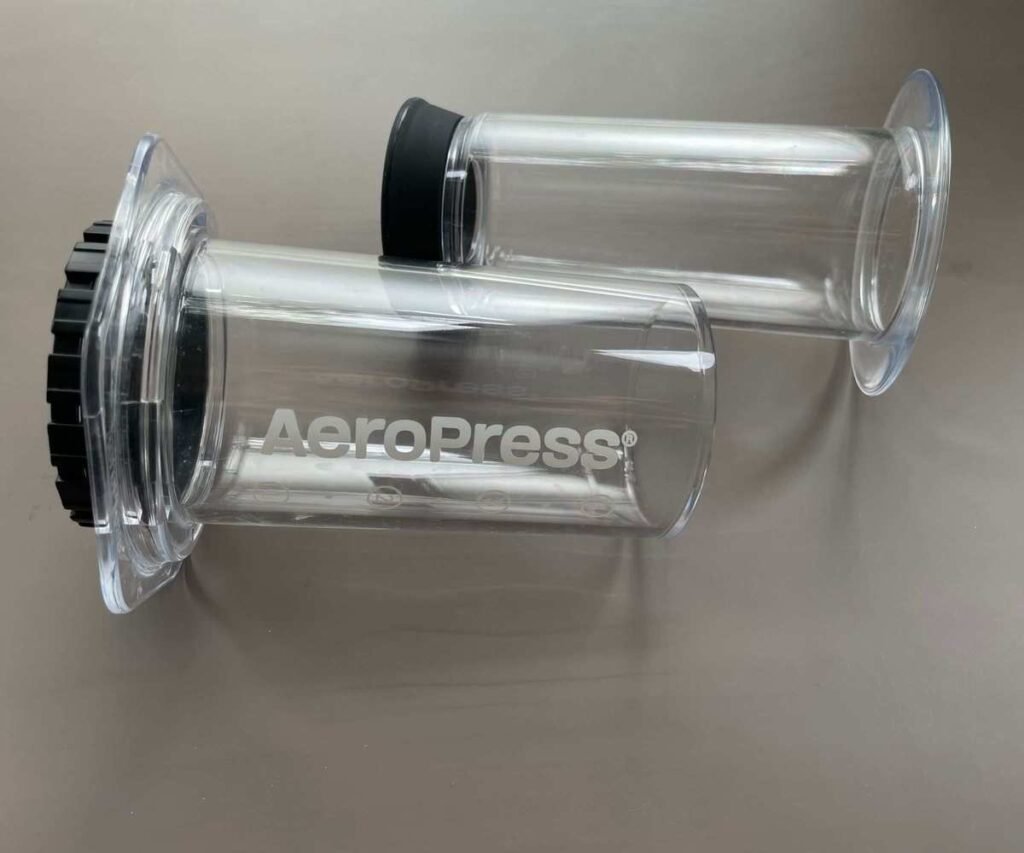 A clear AeroPress in parts on a table, ready to use to make the perfect AeroPress coffee