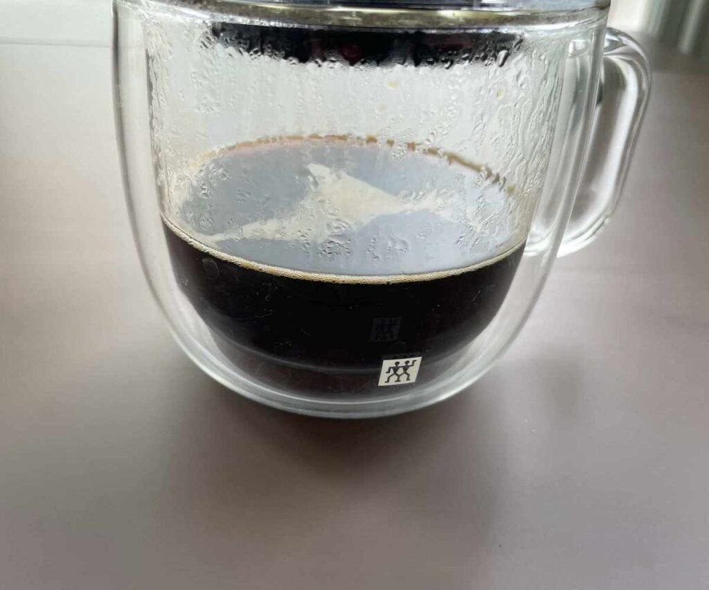 Brewing coffee from the AeroPress into the cup