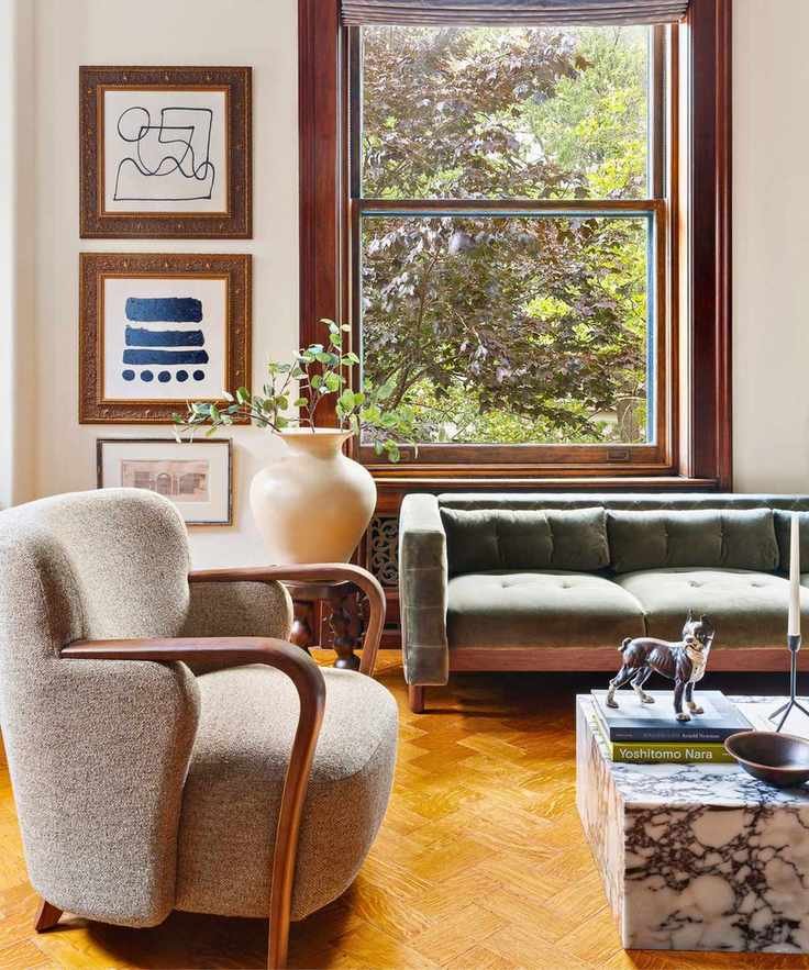 bedroom seating area with modern sofa and coffee table and framed art on wall